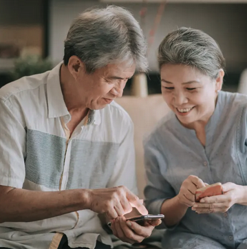 A man and women looking at cell phones together